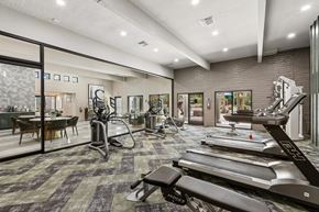 Tucson apartment for rent - A gym with treadmills, weights, and exercise equipment.