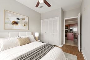 Austin apartment for rent - A bedroom with a large bed and a painting on the wall.