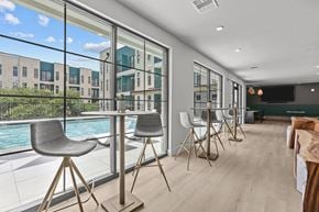 Austin apartment for rent - A modern dining room with a pool table and chairs.