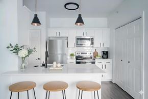 New Braunfels apartment for rent - A modern kitchen with white cabinets and a stainless steel refrigerator.