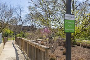 Nashville apartment for rent - a wooden bridge in a park with a sign that reads