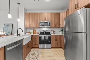 Austin townhouse for rent - A modern kitchen with wooden cabinets and stainless steel appliances.
