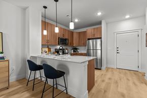 Austin townhouse for rent - A kitchen with a white counter and wooden cabinets.
