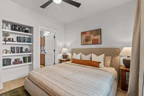 Austin townhouse for rent - A bedroom with a large bed and a ceiling fan.