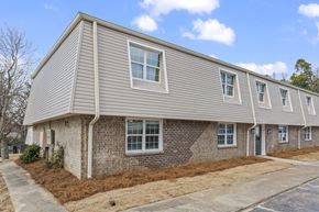 Jonesboro apartment for rent - an exterior view of a gray house with brick and siding
