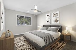 Mableton townhouse for rent - a bedroom with a bed and a ceiling fan