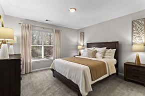Stockbridge apartment for rent - A bedroom with a large bed and a window with curtains.