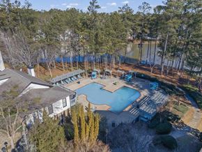 Lilburn apartment for rent - an aerial view of a pool and a house near a lake