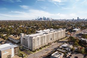 Houston apartment for rent - an aerial view of an apartment building with the skyline in the background