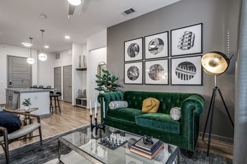 Dallas apartment for rent - a living room with a green couch and a glass table