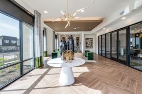 Mckinney apartment for rent - A modern dining room with a white table and a chandelier.