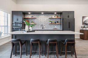 Killeen apartment for rent - A kitchen with a white countertop and black bar stools.