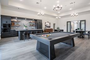Killeen apartment for rent - A pool table is in the middle of a room with a kitchen in the background.
