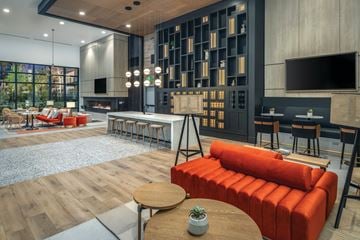 Scottsdale apartment for rent - A modern living room with a red sofa and a wooden coffee table.