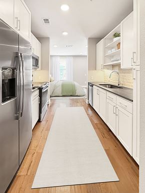 Stafford apartment for rent - A kitchen with a white refrigerator and white cabinets.