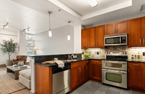 San Diego townhouse for rent - A modern kitchen with wooden cabinets and stainless steel appliances.