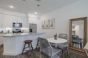 Houston apartment for rent - a small dining area next to a kitchen with a breakfast bar