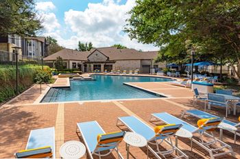 Expansive, sparkling pool with water feature and poolside cabana