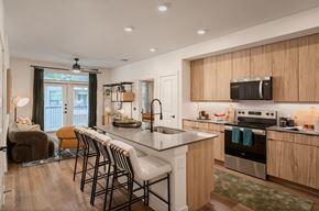 Austin apartment for rent - A kitchen with a large island and bar stools.