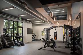 Austin apartment for rent - A gym with a variety of equipment including treadmills, weights, and exercise machines.