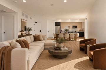 Los Angeles apartment for rent - A living room with a white couch and brown pillows.