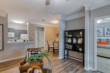 Lee's Summit apartment for rent - A living room with a brown leather chair and a glass table.