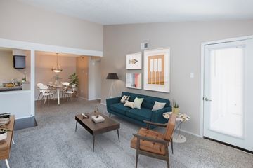 Arlington apartment for rent - A living room with a blue couch and a coffee table.