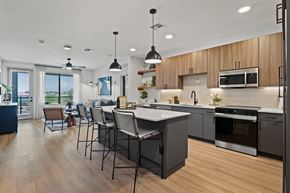 Phoenix apartment for rent - A modern kitchen with wooden cabinets and a large island.