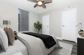Phoenix apartment for rent - A bedroom with a large bed and a ceiling fan.