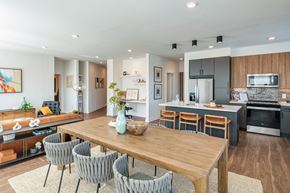 Houston apartment for rent - A modern kitchen with a dining table and chairs.