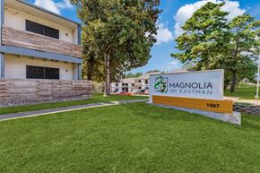 Longview apartment for rent - a sign with magnolia on eastman written on it in front of a building