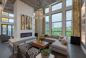 Floor-to-ceiling clubhouse windows overlooking magnolia and downtown fort worth