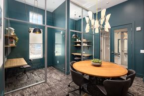 Franklin apartment for rent - A modern dining room with a round wooden table and chairs.