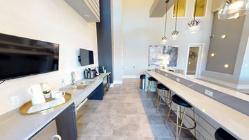 Dayton apartment for rent - A modern kitchen with a long counter and bar stools.