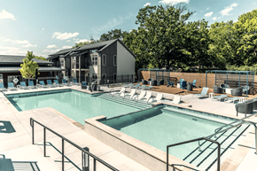 Nashville apartment for rent - A large outdoor swimming pool with a metal railing.