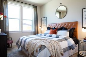 Houston apartment for rent - a bedroom with a bed and two windows