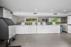 Austin apartment for rent - a kitchen with white cabinets and a counter with chairs