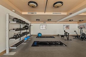 Mesa apartment for rent - A gym with a variety of equipment including weights, a balance ball, and a stationary bike.