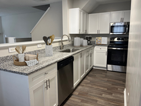 Raleigh apartment for rent - a kitchen with white cabinets and granite counter tops
