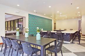 Houston apartment for rent - A dining room with a long table and chairs.