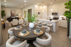 Richmond apartment for rent - A modern dining room with a round table set for six.