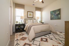 Richmond apartment for rent - A bedroom with a large bed and a rug on the floor.