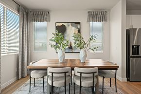 Tolleson apartment for rent - a dining room with a wooden table and chairs and two vases with plants