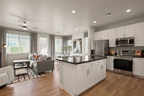 Tolleson apartment for rent - a kitchen and living room with white cabinets and a black counter top