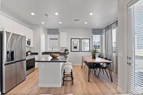 Tucson apartment for rent - A modern kitchen with a dining table and chairs.