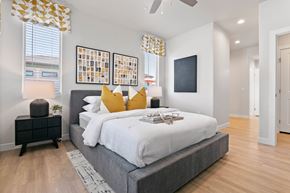 Tucson apartment for rent - A bedroom with a large bed and a ceiling fan.