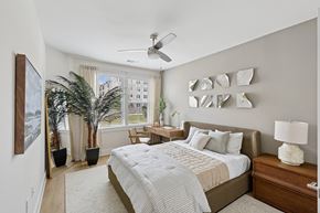 Pooler apartment for rent - A bedroom with a large bed and a ceiling fan.