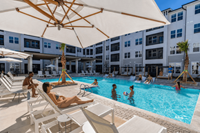 Pooler apartment for rent - A group of people are enjoying a sunny day at the pool.
