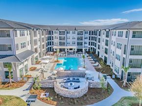 Pooler apartment for rent - A large apartment complex with a pool and a patio area.