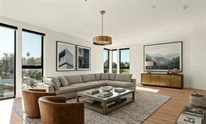 Los Angeles apartment for rent - A modern living room with a large grey sofa, a coffee table, and a view of the city.